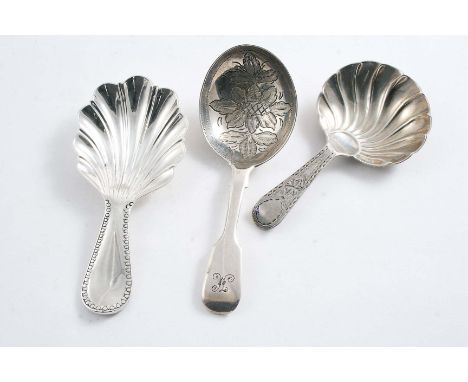 A GEORGE III CADDY SPOON with a bright-engraved stem and a fluted oval bowl, by William Welch of Exeter, c.1790 and two other