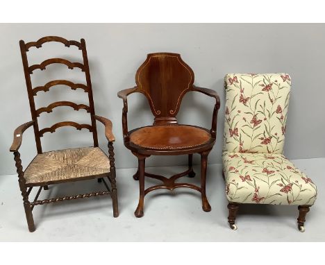 An Edwardian oval shaped Captains chair by Jenks &amp; Wood, mahogany frame with scrolled arms, shield shaped back, leather s