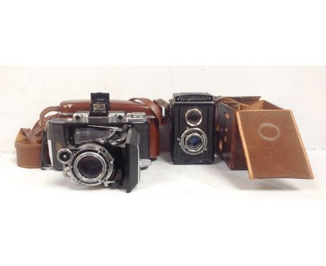 A Zeiss Ikon Super Ikonta folding camera no. 999282 in brown leather case, together with a Voigtlander camera in brown leathe
