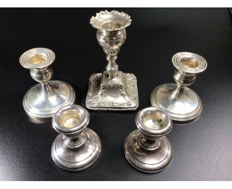 A pair of silver loaded squat candlesticks, Birmingham, 1930, maker's mark of S Blanckensee &amp; Son Ltd, 8cm high, together