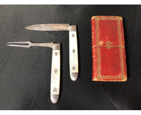 An early 19th century silver bladed and mother of pearl handled miniature knife and fork, in red and gilt tooled case modelle