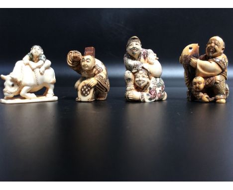 Four early 20th century Japanese carved and stained ivory netsuke, each signed 