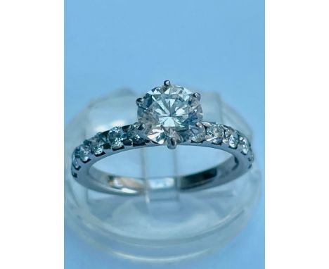 An 18ct white gold diamond ring set with a round brilliant cut diamond in a high set six claw  setting, The solitaire diamond