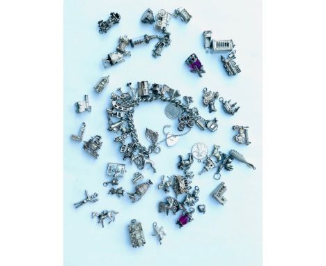 A silver heavy curb link charm bracelet with 22 various silver charms including an aeroplane, a windmill, a radiogram, a hors