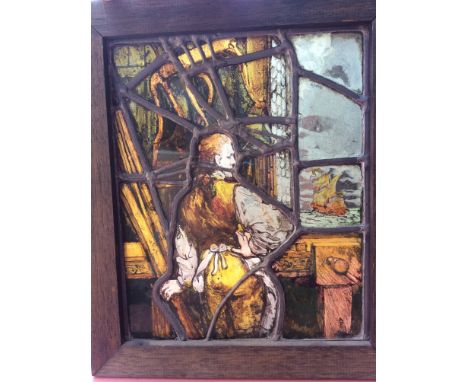 A 19th century leaded and stained glass rectangular panel featuring an 18th century shipwright looking at a a galleon in full