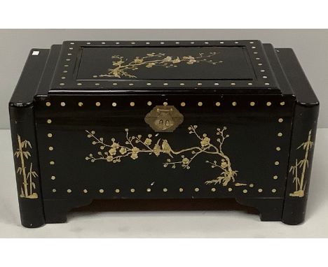 A Chinese black lacquered camphor trunk depicting a mother of pearl bird scene to the top with gold painted bird and boat ima