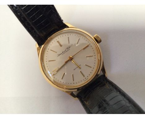 An 18ct gold International Watch Company wristwatch c.1960's, the cream dial with applied gold batons denoting hours, on blac