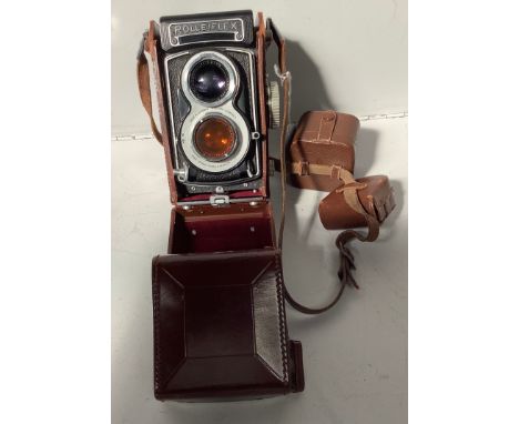 A German Rolleiflex Synchro - Compur X camera, no. 2319592, in brown leather case with flash and coloured lenses in brown lea
