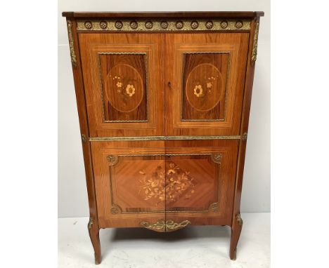 A reproduction Kingwood marquetry French style cocktail cabinet with gilt-metal mounts, glass shelf, mirrored back, pull out 