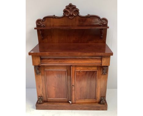 Victorian mahogany chiffonier with scrolled raised back and shelf, above a pair of cupboard doors on plinth base, 107cm wide,