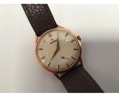 A gents 18ct gold manual wind Omega wristwatch, the striped, crosshair dial with applied gold batons denoting hours and subsi