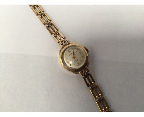 A ladies 9ct gold Rotary wristwatch, the silvered dial with batons denoting hours and quarterly Arabic numerals, on 9ct gold 