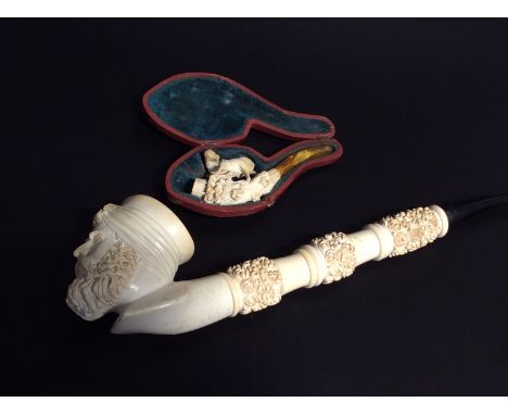 A large meerschaum tobacco pipe with bowl carved as a bearded Turk, 30cm long, together with a small meerschaum pipe in fitte