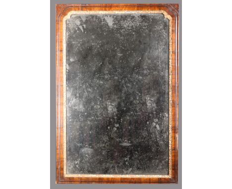 A Queen Anne cross grain walnut looking glass, with original Vauxhall type plate and gilt gesso slip, 44.5cm wide