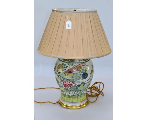 A 20th century Chinese baluster lamp, decorated with ho ho bird in a landscape, with pleated silk shade