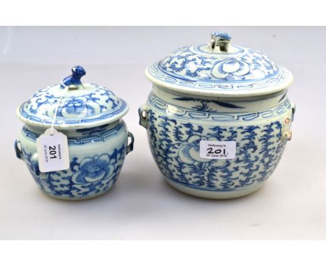 Two 18th century Chinese blue and white covered jars, each with kylin finial and pierced handles, simply decorated with flowe