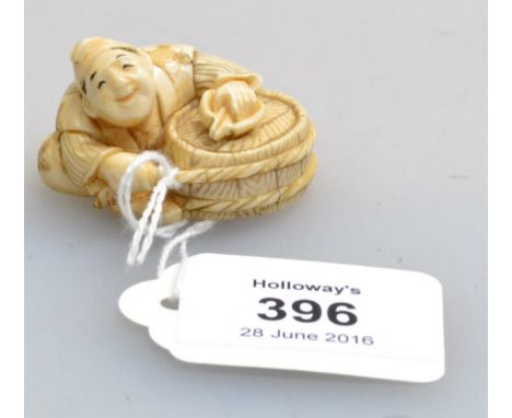 A Japanese Meiji period carved ivory netsuke, in the form of cooper binding a barrel with rope, 4.6cm wide