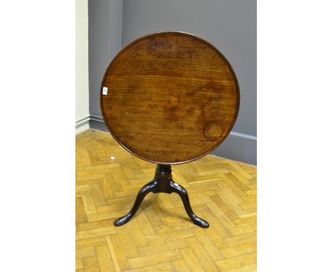 An early George III mahogany circular dish topped tripod table, with birdcage and gun barrel column over broad knee cabriole 