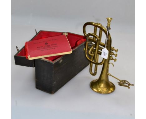 An early 20th century brass cornet, fitted with a lyre shaped sprung music stand, with three mouth pieces, in a wooden box wi