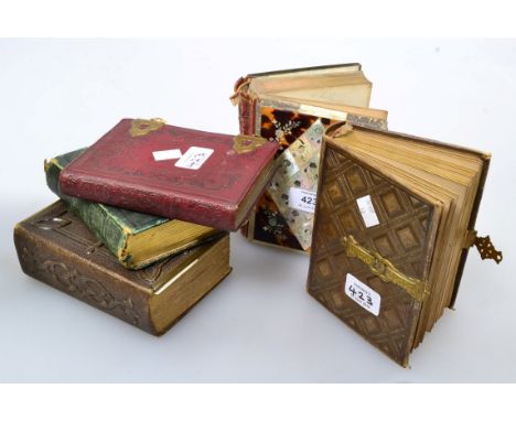 A 19th century mother of pearl and tortoiseshell visiting card album, containing seventeen photographic portrait and other ca