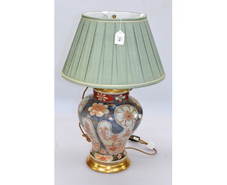 A 20th century Japanese Imari baluster lamp, with brass mounts and pleated silk shade