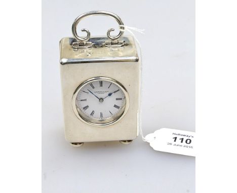 An early 20th century silver cased dressing table clock, of cube form, with bun feet and bale handle, London 1905, by A Barre