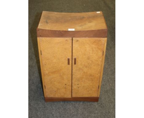 Alexander Graffety-Smith, a craftsman built walnut cabinet, having a dished top over a pair of burr veneer doors enclosing si