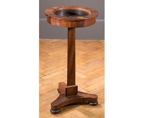A William IV figured rosewood pillar jardiniere, with triangular section column over  triform bases and bun feet, 39cm diamet