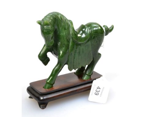 A 20th century dark green Chinese carved nephrite horse, in the Tang style, bearing the name C R Wang, No 36, 15cm long