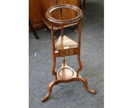 An early  George III oak skeletal shaving stand, with moulded bowl stand and central drawer section, over a tripod base with 