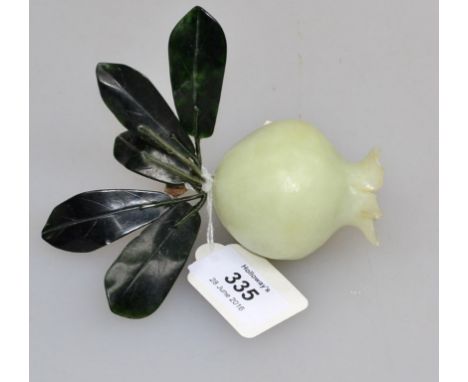 A Chinese carved jade? persimmon, with silk bound wire stems and dark green marble leaves, 9cm