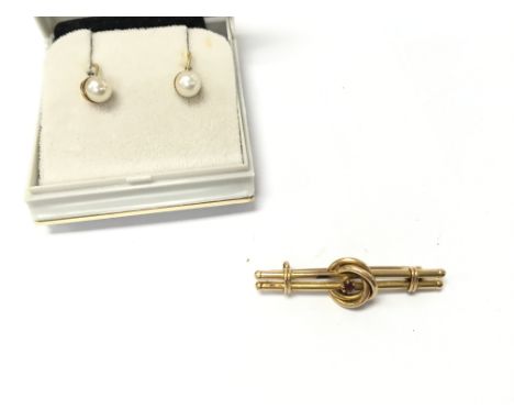 An 18ct gold brooch set with small ruby 2.87g and a pair of 9ct gold pearl earrings. Postage B