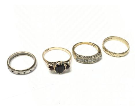 A Collection of 9ct gold rings including a Moissanite ring, ruby set ring, 9ct gold/silver ring. Total weight 9.5g. Postage c