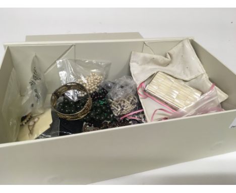 A box containing costume jewellery including a green jade necklace an antique garnet necklace pearl necklaces and other ornam