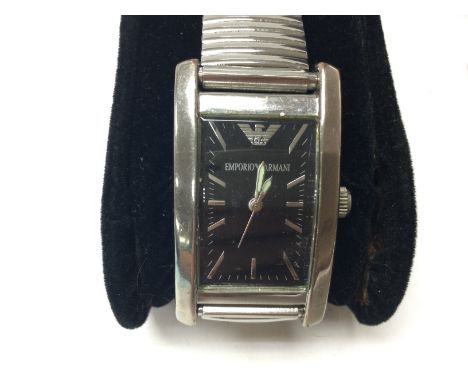 A stainless steel Emporio Armani watch on stretch bracelet. Seen running. Comes with box and papers. Postage B