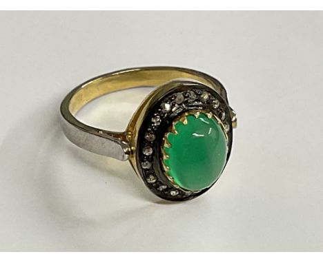 Cabochon green onyx and diamond halo ring, set in silver. Onyx 1.91ct. Diamonds 0.22ct. Ring size approx N. Postage category 