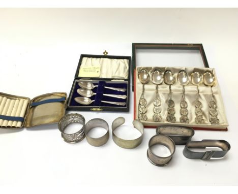 A silver cigarette case napkin rings silver Chinese spoons etc. Postage B