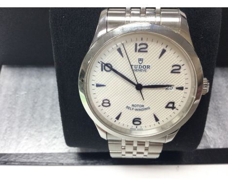 A Tudor 41mm wrist watch. Model 91650. White dial with date window. Stainless steel strap. Comes with box, card, swing tag an