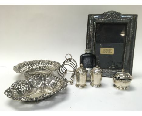 A Collection of silver hallmarked items including bonbon dishes, a photo frame, Scottish silver S/P shakers, rack, non silver