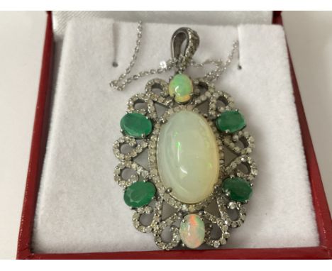 Silver floral style pendant set with opals, diamonds and emeralds on a silver chain, boxed. Opals 11.18ct. Emeralds 2.88ct. D