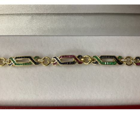 Exciting 18ct yellow gold ruby, emerald, sapphire and diamond â€œfigure of eightâ€ bracelet, boxed. Rubies 0.50ct approx. Sap