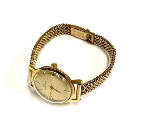 A vintage Jaquet + Girard 18ct gold cased ladies wrist watch together with a 9ct gold strap. 28.93g (A)