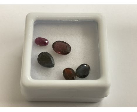 Parcel of loose gemstones, including sapphire, ruby and garnet, boxed. Sapphires 1.47ct. Ruby 0.37ct. Garnet 1.39ct. Postage 