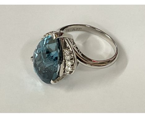 Large and weighty certificated platinum ring set with a mixed pear cut deep blue topaz and RBC diamonds. Topaz 13.72ct. Diamo