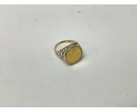 A 9ct gold coin set ring approx weight 4.8 grams. Size R.