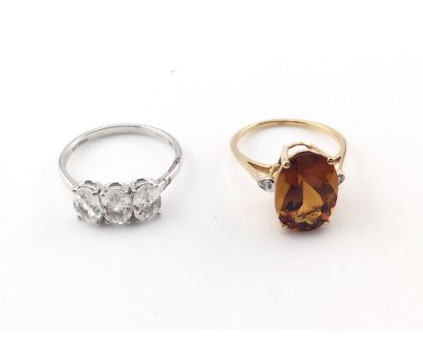 A 10k white gold three stone ring 2.8g and size R and a 14k gold cocktail ring size P and 3.40g Postage B