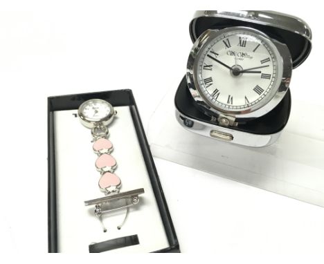 Two time pieces, a heart design brooch pendant watch by Ravel and a pop up travel clock by W Widdop