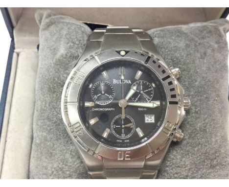 A Bulova stainless steel Chronograph with black dial. Comes with box and papers and seen working. Postage B