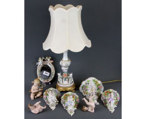 A group of cherub porcelain items including a gilt mounted table lamp (A/F), largest bracket H. 16cm.