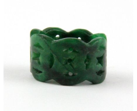 A Chinese carved green jade ring, W. 1.5cm. Internal Dia. 1.9cm.